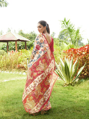 Traditional purple floral printed saree with artistic woven pallu and matching blouse showcased outdoors.