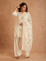 Woman wearing a white traditional outfit with floral patterns on a beige background