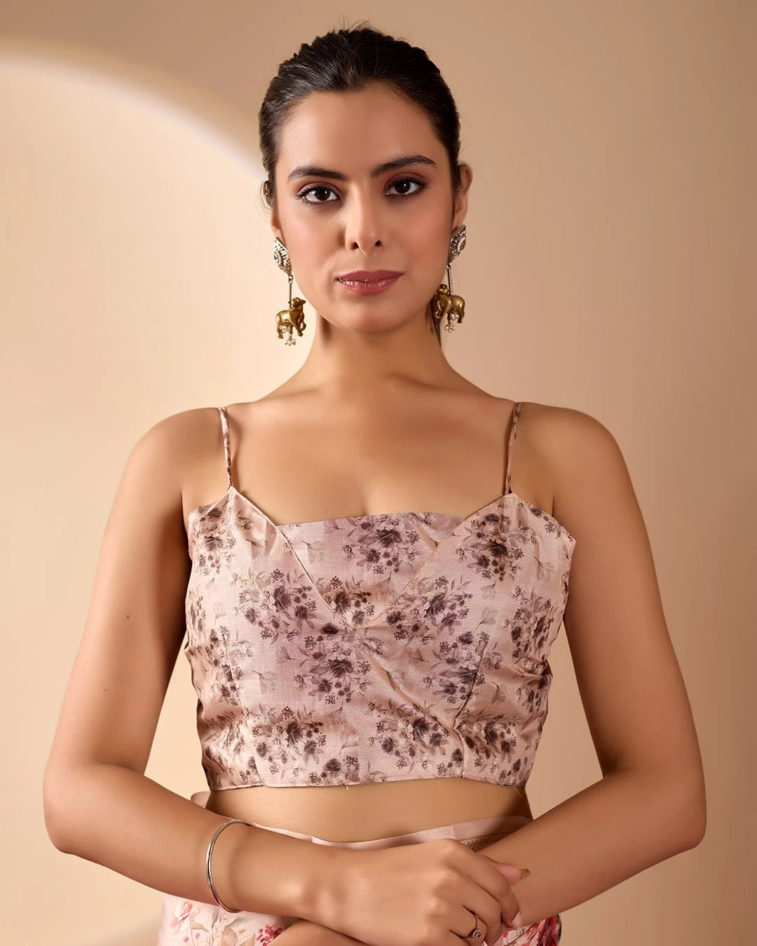 Woman wearing a floral top against a beige background