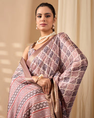 Woman wearing a patterned saree with a beige background