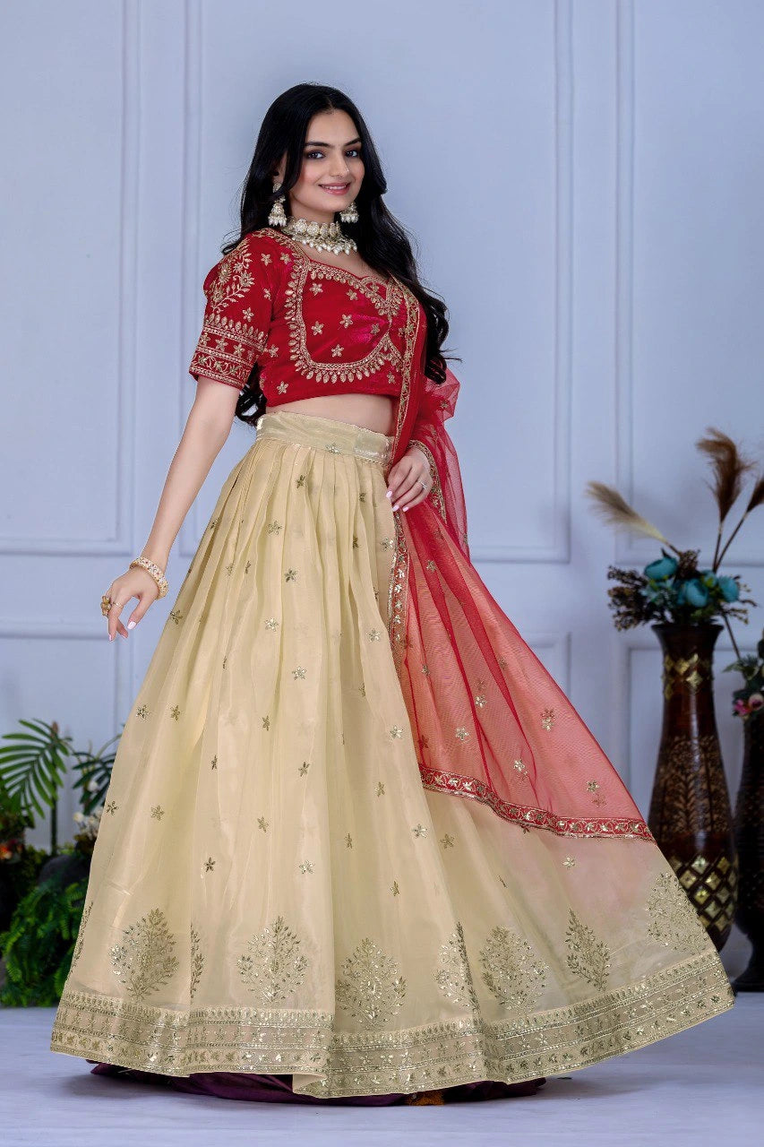 Woman wearing a red and beige embroidered traditional outfit with a white background