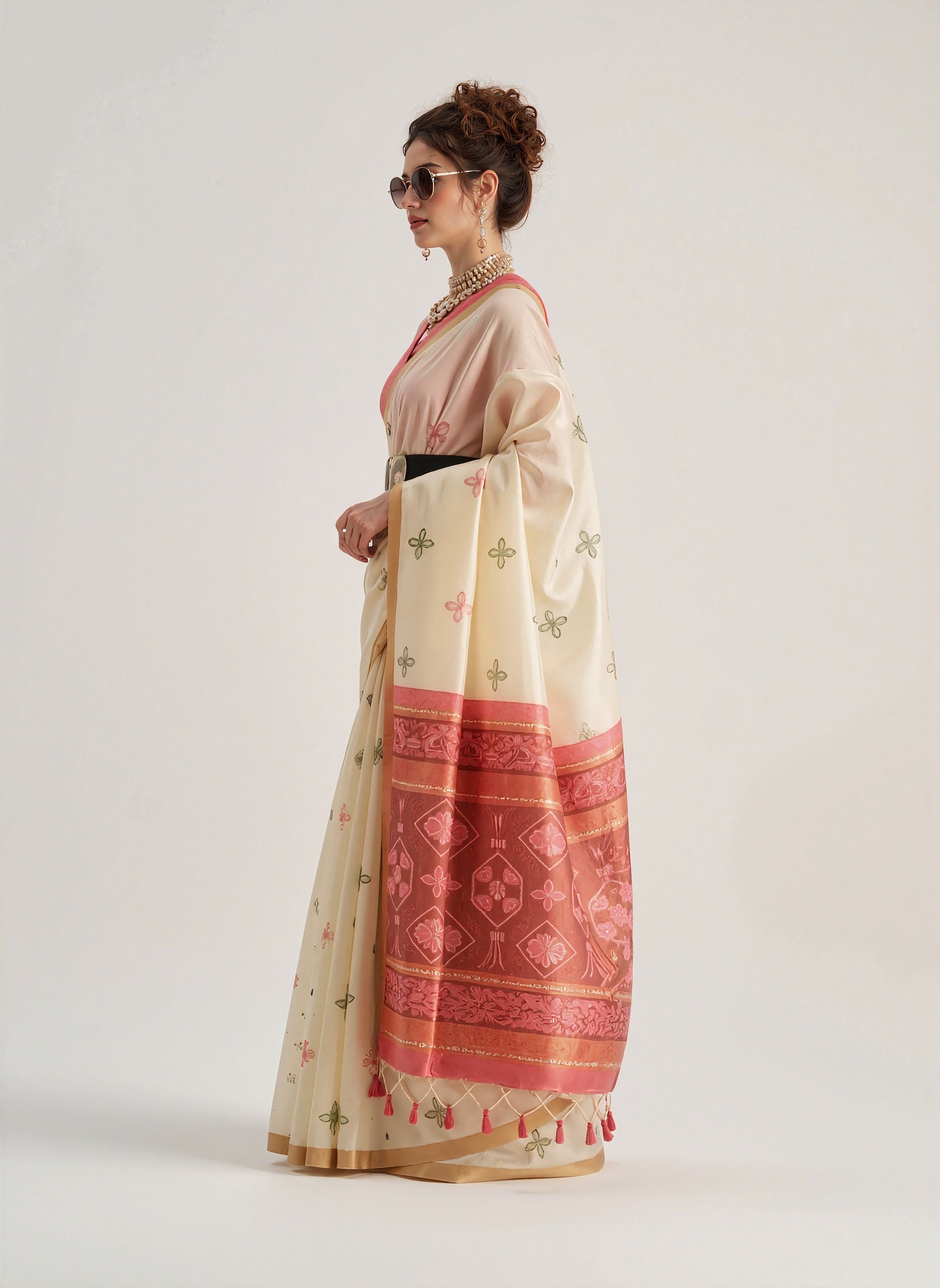 Beige Patola silk saree featuring traditional geometric and floral weaving patterns. Includes a matching blouse piece. Lightweight and elegant, ideal for festive and ceremonial occasions.