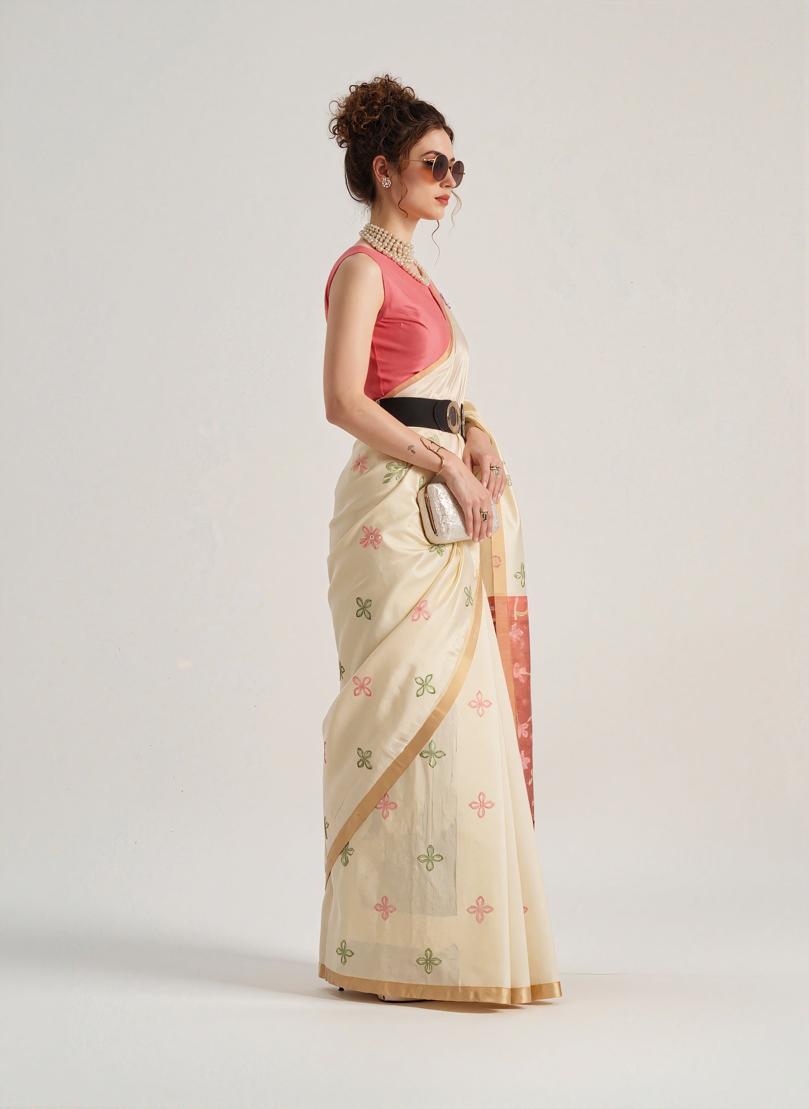 Beige Patola silk saree with intricate geometric and floral weaving patterns. Includes a matching blouse piece. Lightweight and elegant, ideal for festive and ceremonial occasions.