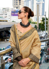 Woman in a beige saree with cityscape background