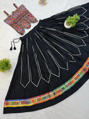 Full spread flat lay of 4-meter black circular lehenga skirt with patola border and Kutchi embroidered choli