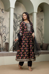 Woman in a floral dress standing in a decorative interior setting