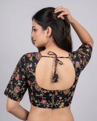 Black embroidered viscose blouse styled for festive and party wear.