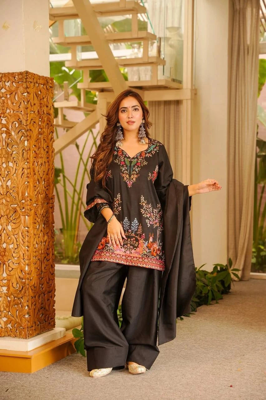 Woman in traditional outfit standing in a decorated indoor setting
