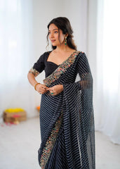 Woman wearing a traditional saree with a blouse in a minimal setting