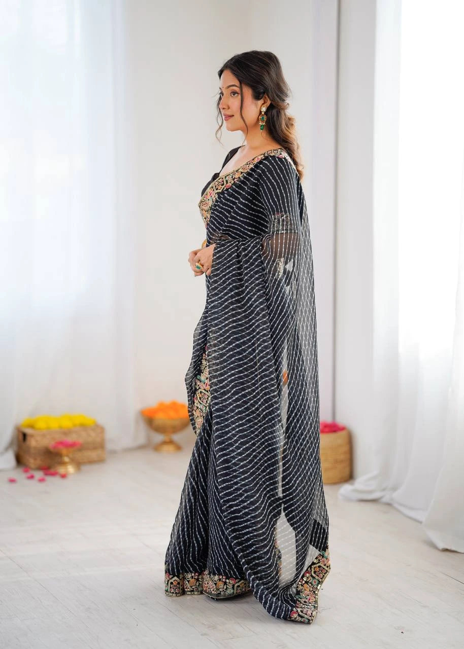 Woman wearing a black and gold saree with a white background