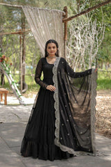Woman in a black traditional outfit with a sheer dupatta outdoors