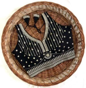 Black embroidered baby bib on a woven basket