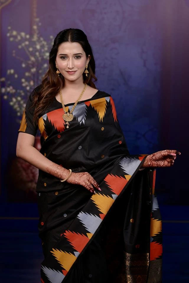 Woman in a colorful saree against a dark background