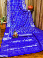Blue saree with white patterns on a wooden surface