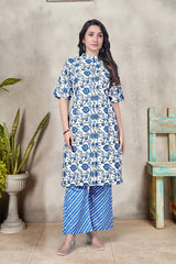 Woman wearing a blue and white floral dress with matching pants against a neutral background.
