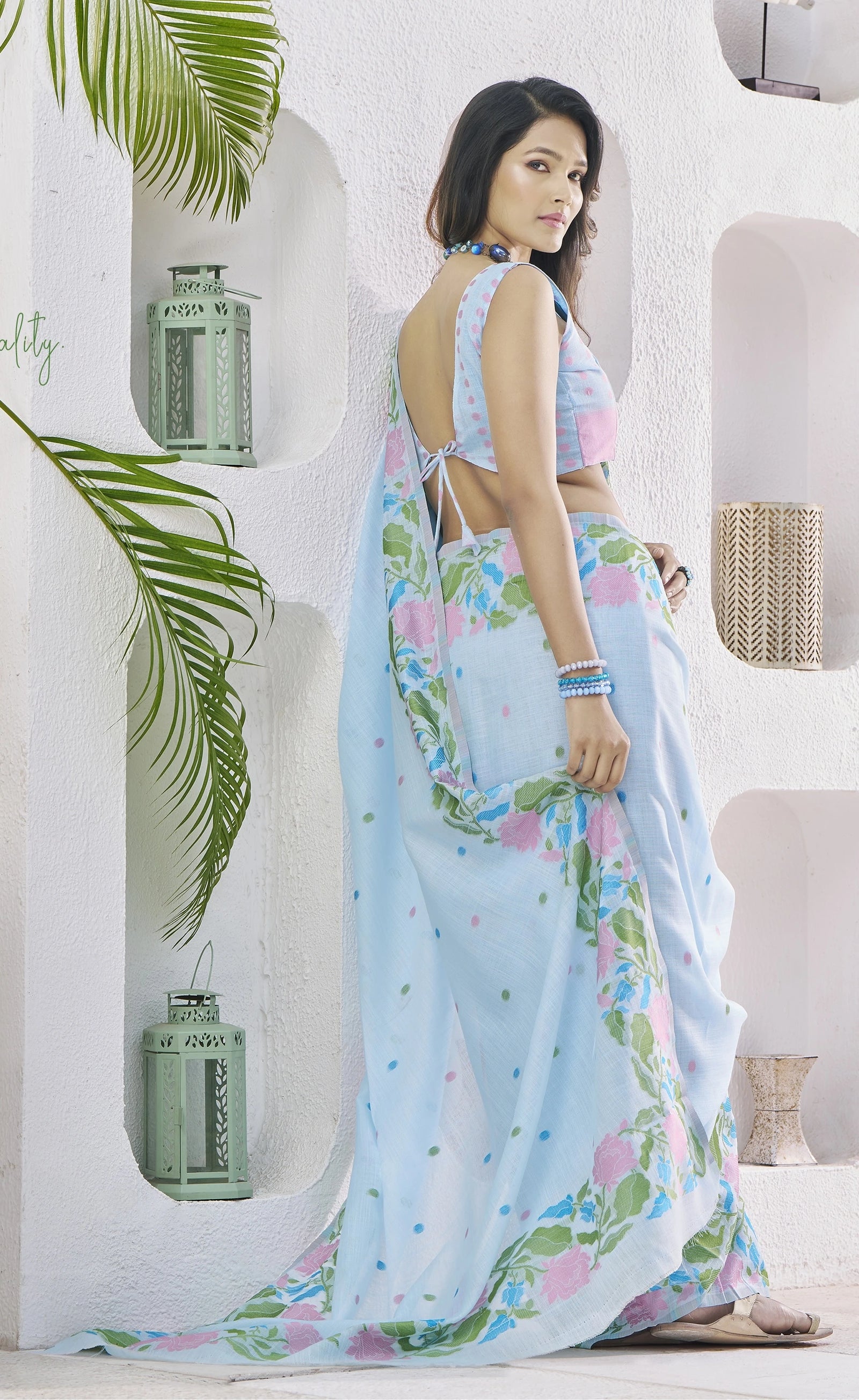 Woman wearing a floral saree in a bright interior setting