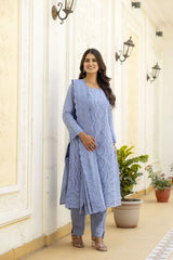 Woman wearing a light blue kurta with lace details in an indoor setting.