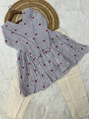 Striped shirt with red heart patterns on a textured surface