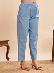 Light blue pants worn by a person on a beige background