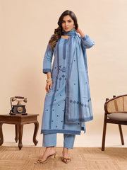 Woman wearing a blue traditional outfit with a matching dupatta in a room setting.