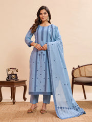 Woman wearing a light blue traditional outfit with a matching dupatta in a room setting.