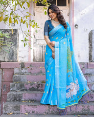Woman in a blue saree standing on steps outdoors