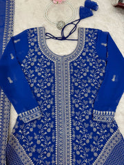 Blue embroidered traditional outfit with white patterns on a light background