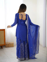 Woman wearing a blue traditional outfit with a white background