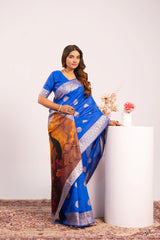 Woman wearing a blue saree with a colorful border against a white background