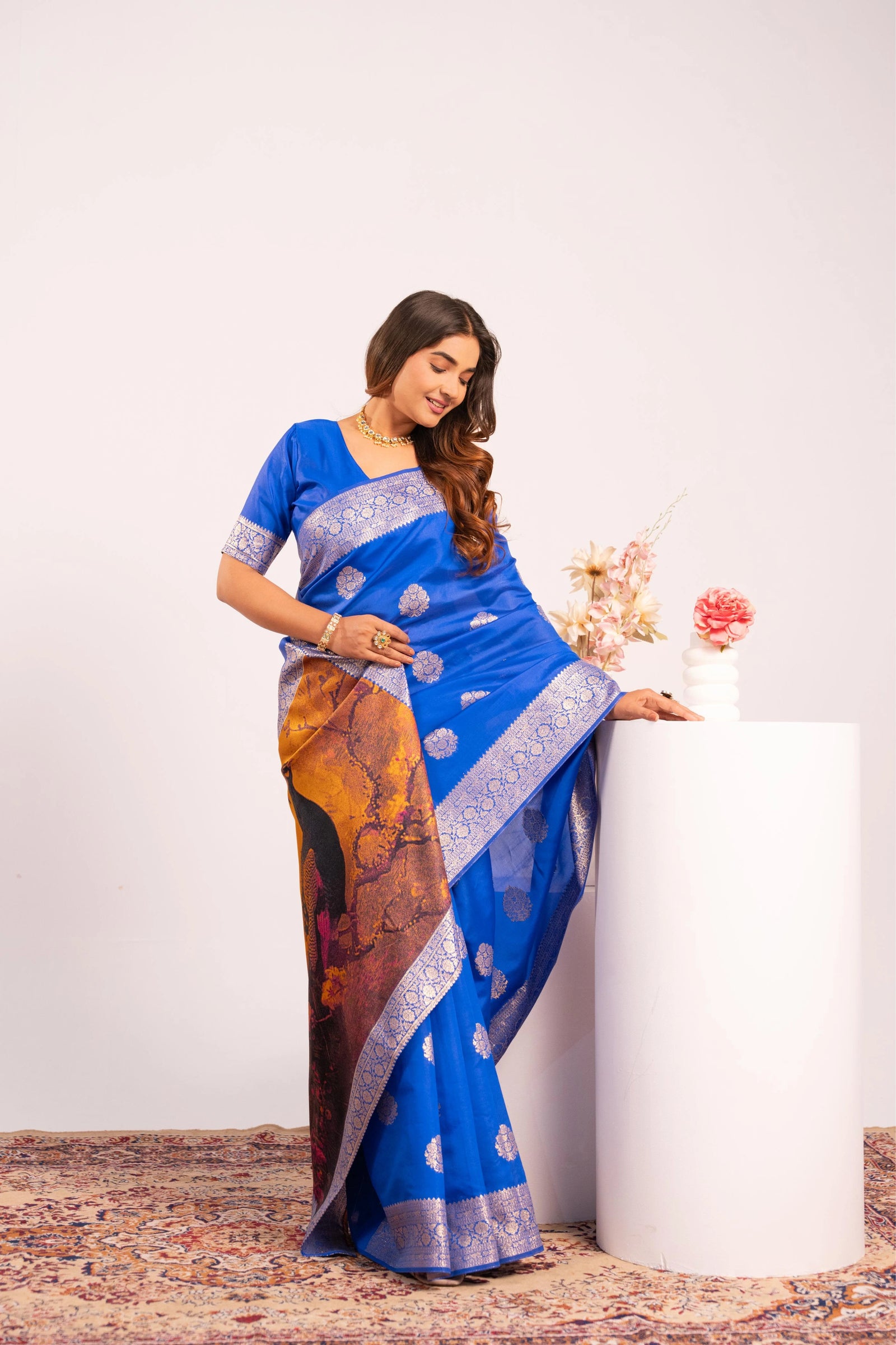 Woman wearing a blue saree with a white background