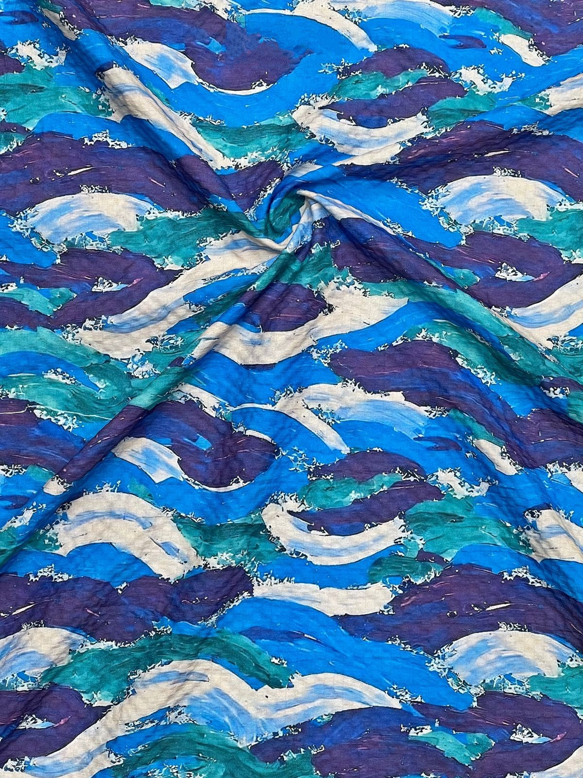 Close-up of fabric with blue and purple wave pattern