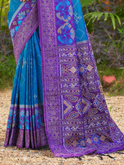 Blue and purple saree with intricate patterns on a natural background