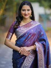 Woman wearing a traditional blue and purple saree with a blurred background