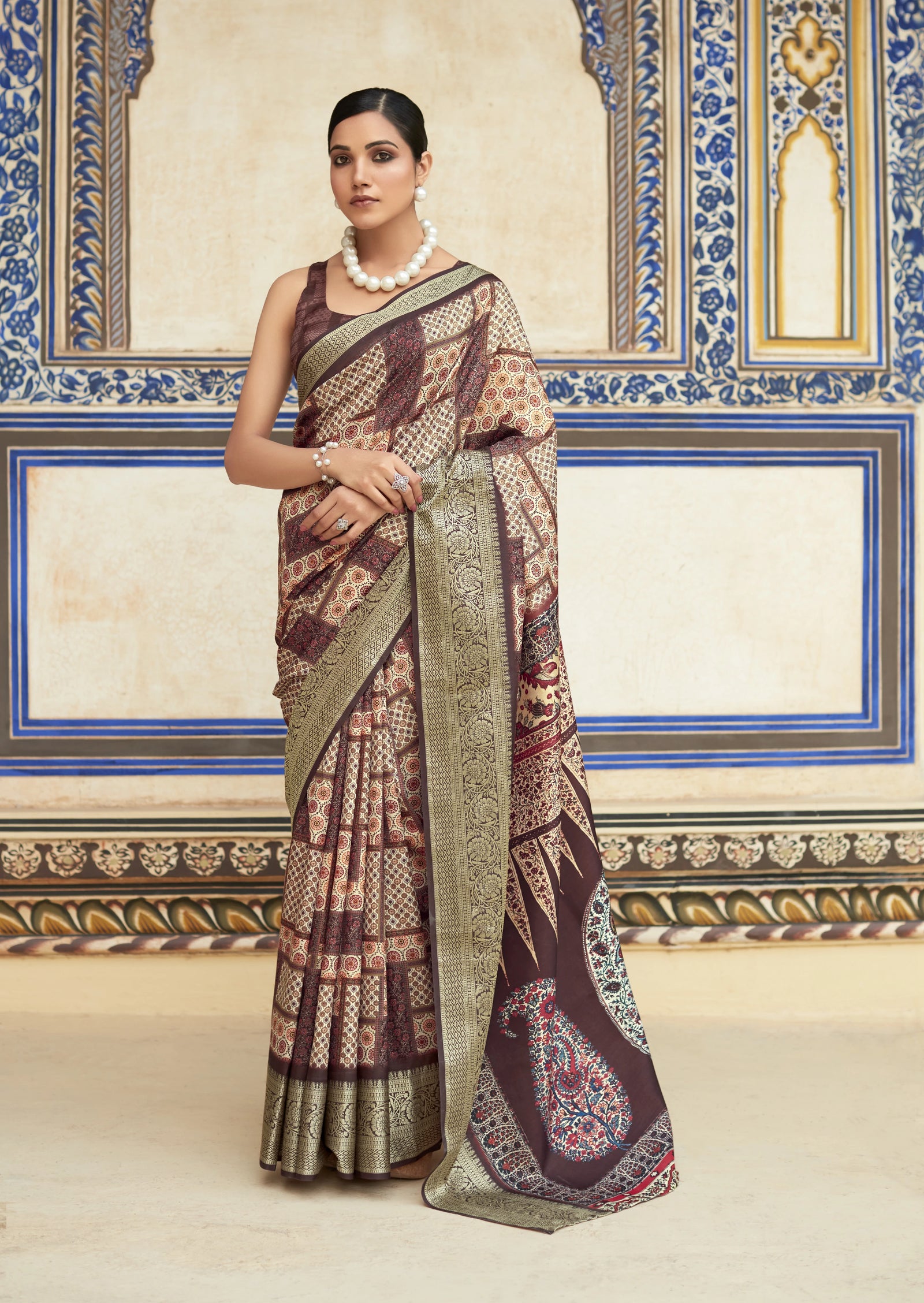 Woman wearing a traditional saree in a decorated room