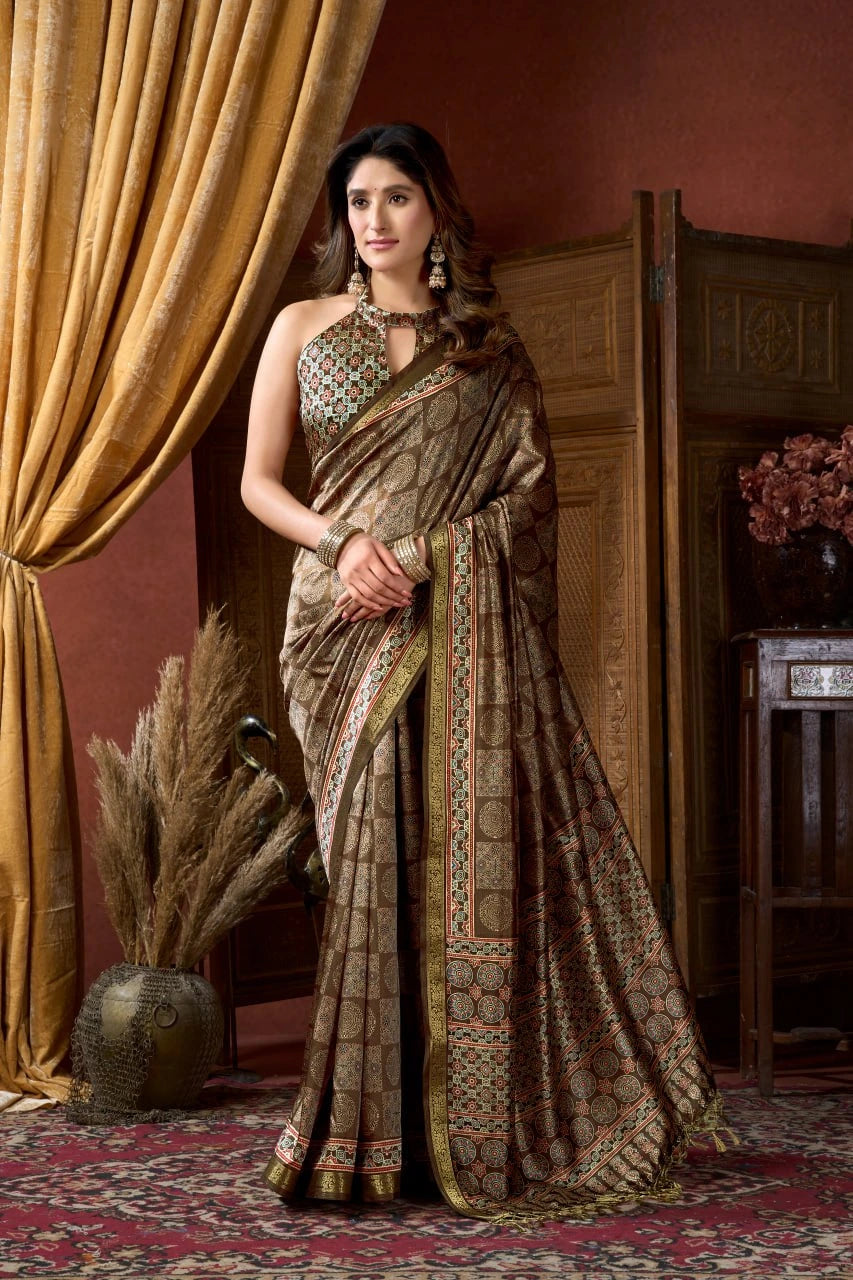 Woman in a traditional saree standing in a room with decorative elements.
