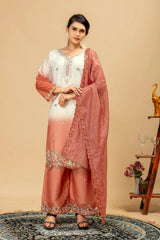 Woman wearing a peach and white traditional outfit with a matching dupatta against a beige background.