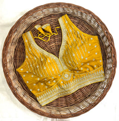 Yellow embroidered blouse on a woven basket