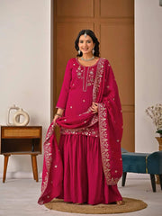 Elegant crimson red embroidered suit featuring intricate zari border and neckline design.