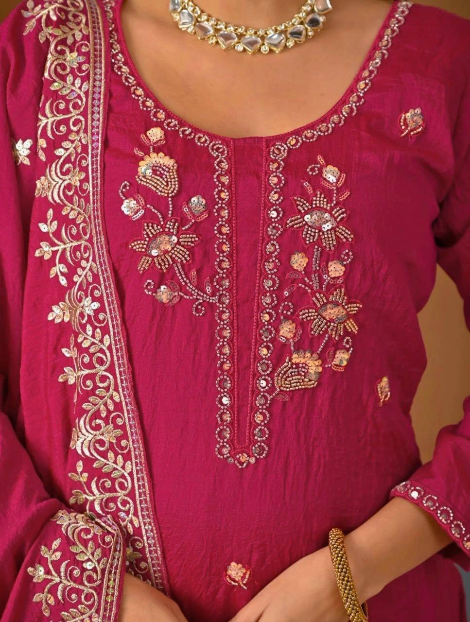 Stylish crimson red Vichitra suit with heavy embroidery on sleeves and hemline.