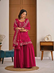 Close-up of crimson red georgette fabric highlighting detailed embroidery and zari craftsmanship.