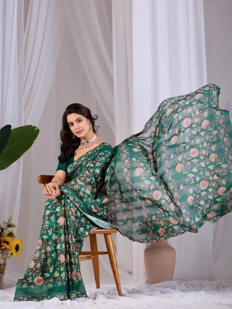 Dark Green Floral Saree – seated view with pallu in graceful motion