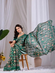 Dark Green Floral Saree – seated view with pallu in graceful motion
