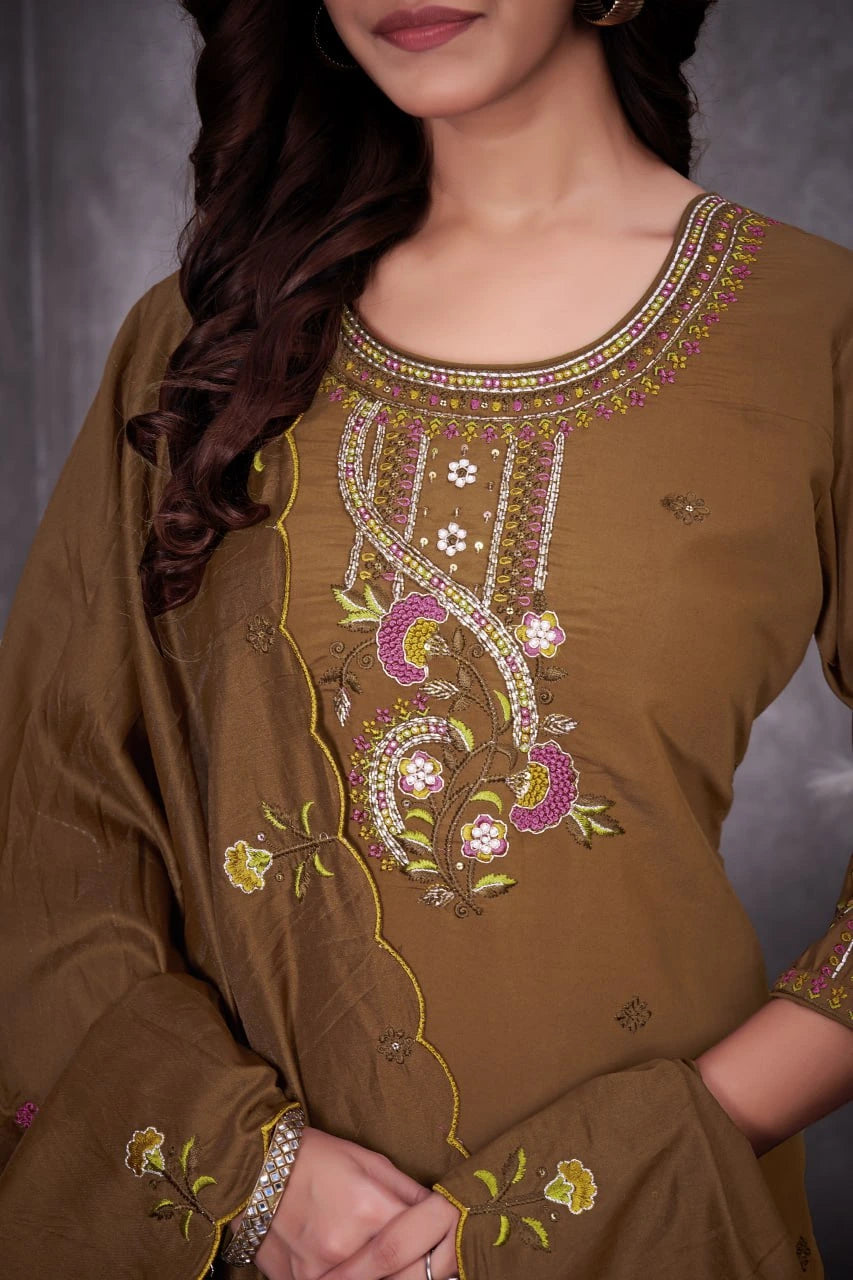 Brown embroidered dress with intricate patterns on a plain background