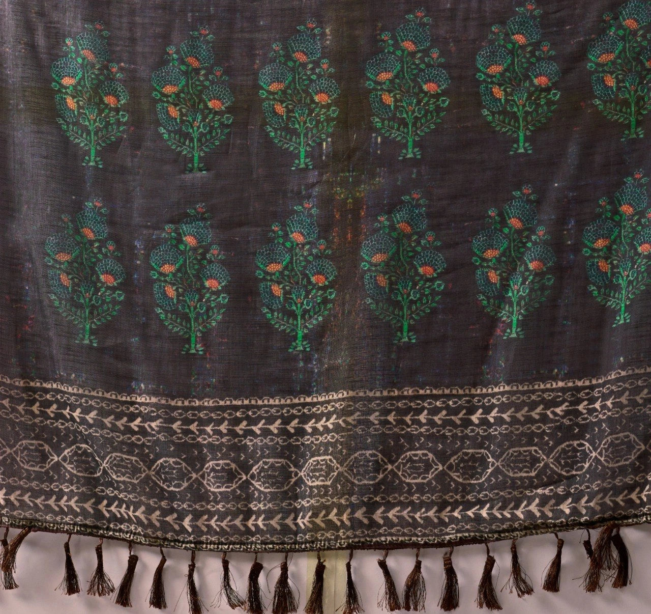 Textile with tree patterns and a decorative border on a white background