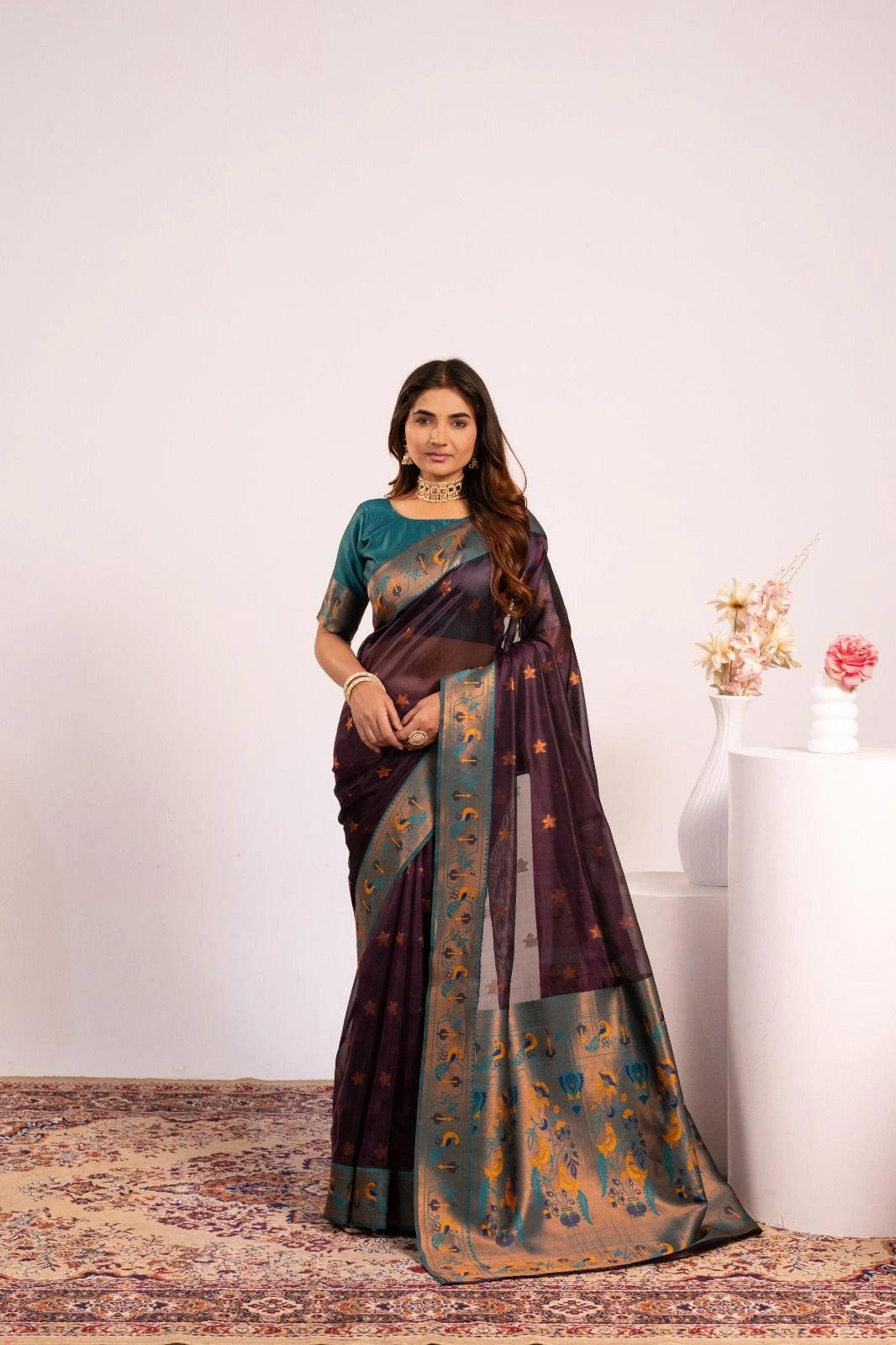Woman wearing a traditional saree with a floral background
