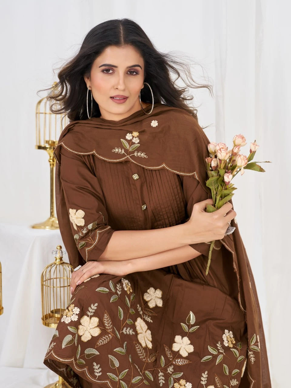 Charming ethnic wear ensemble in rich brown tones, highlighted by handcrafted floral embroidery and classic styling.