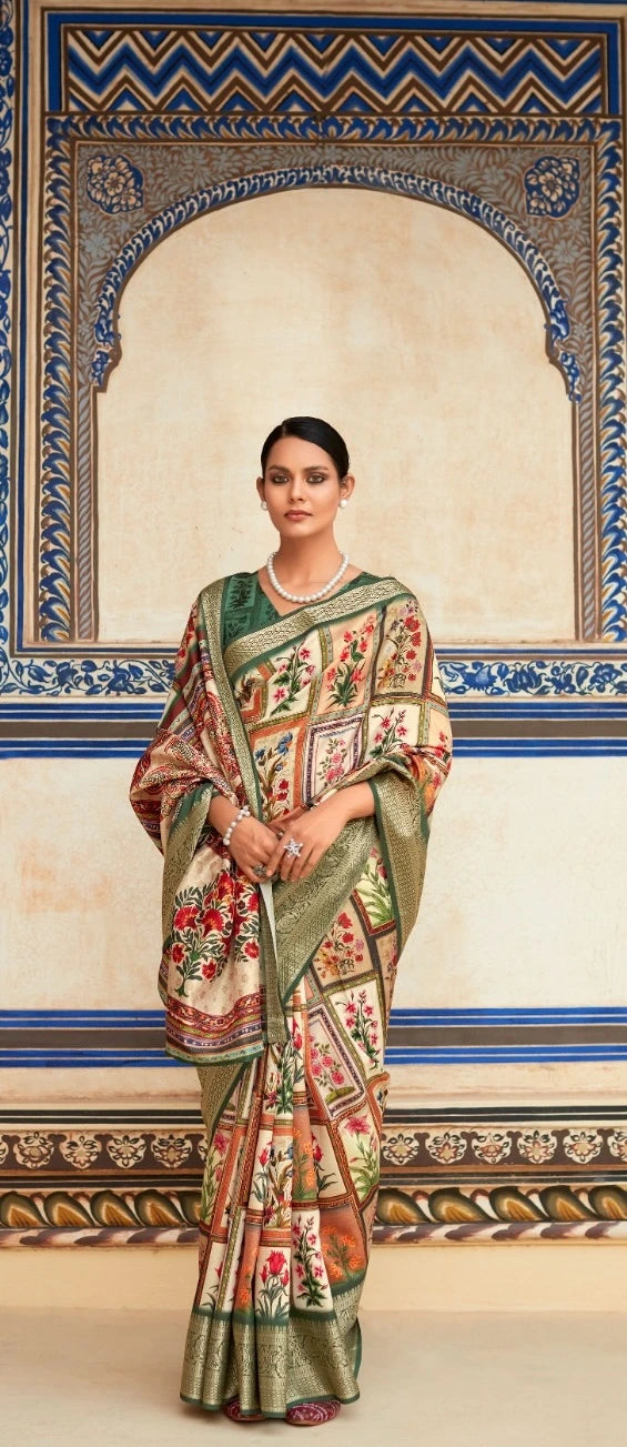 Woman in a traditional saree standing in front of an ornate wall.