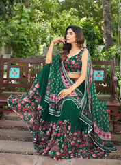 Woman in a green floral traditional outfit sitting on a bench outdoors.