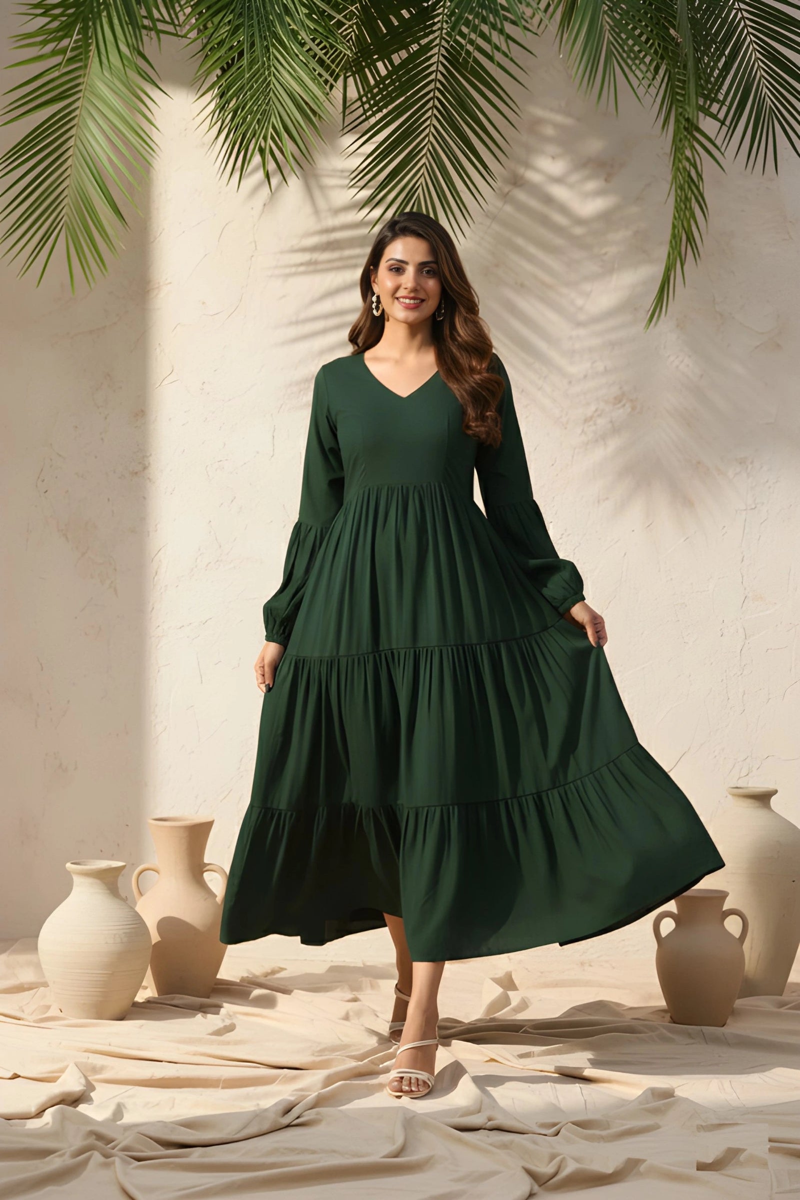 Woman wearing a green dress standing in a sunlit room with decorative vases and plants.
