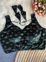 Black floral-patterned top on a textured surface with flowers in the background